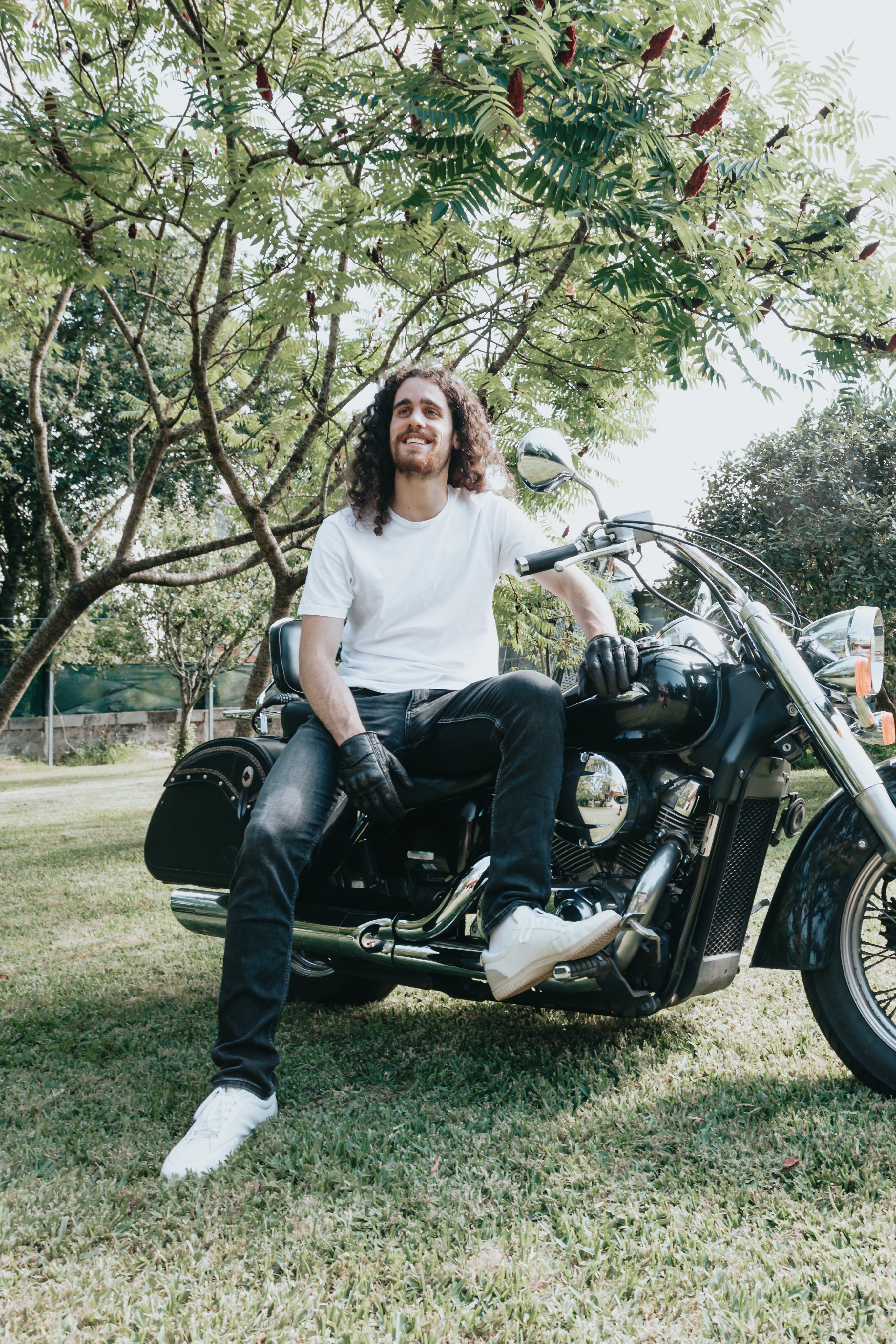 files/person-leans-on-a-motorcycle-on-green-grass.jpg